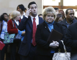 In this Wednesday, Jan. 22, 2014, photo, job seekers line up to meet prospective employers during a career fair at a hotel in Dallas. The government issues the January jobs report on Friday, Feb. 7. 2014. (AP Photo/LM Otero)